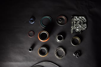 Transmission seals and o-rings laid out on a workbench for a rebuild