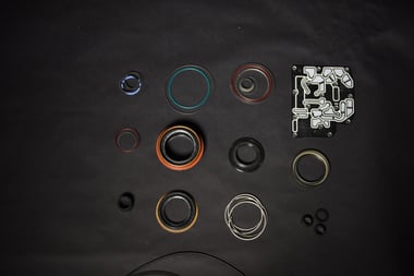 Aftermarket transmission seal kit laid out on a workbench