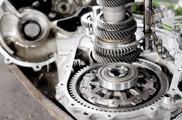 Disassembled automatic transmission with multiple speeds on a workbench