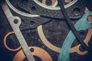 A selection of transmission seals on a workbench in a rebuild shop