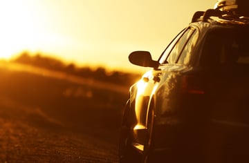 vehicle with EPS system driving down rural road during sunset