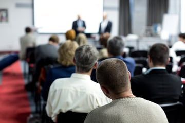 Auto shop employees attending an information session at an industry training event expo