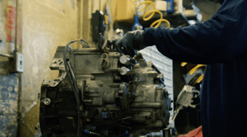 Transmission rebuild in progress on a workbench using OE components